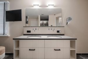 a bathroom with a sink and a mirror at Haus Hyggelig in List +50 photos