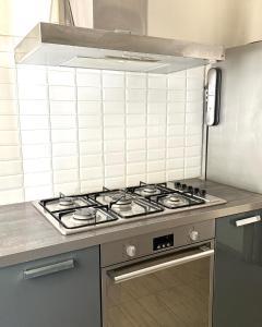 a kitchen with a stove top oven in a kitchen at Volupta' s house Trastevere Station in Rome