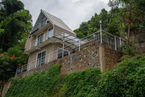 a house on top of a stone wall at The Tranquil Cabana - kandy in Rattanadeniya