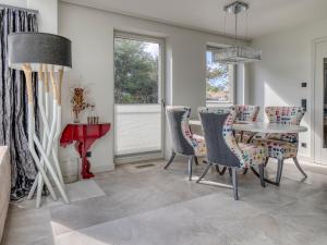 a dining room with a table and chairs at Haus Watt`n Blick in List
