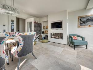 a living room with a table and chairs and a fireplace at Haus Watt`n Blick in List