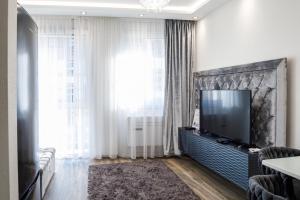 a living room with a flat screen tv on a wall at Rebany Apartman 2 Free parking, Central Location in Debrecen