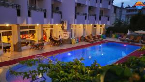 a large swimming pool in front of a building at Grand Didyma Hotel in Didim