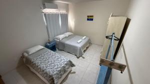 a room with two beds and a cross on the wall at Apartamento Baixu 2 in Prado