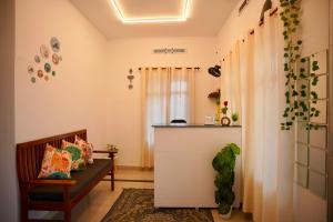 a living room with a bench and a counter at Roomify Inn in Trivandrum