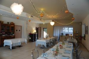 a dining room with white tables and chairs and lights at Il Praedio Della Reale in Ginosa