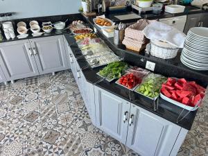 a kitchen with a counter with food on it at Kaptan Pansiyon in Kaş +96 photos