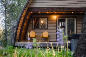 a cabin with two chairs and a table on a porch at A Frame Hot Tub Couple's Getaway in Island Park