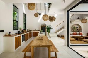 an open kitchen and living room with a wooden table at Terrene Villa in Weligama