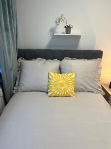 a bed with two pillows on it with at Sara Apartament in Turek