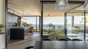 a kitchen and dining room with a view of the ocean at Villa Atreeum in Dubrovnik