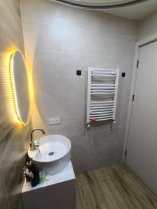 a bathroom with a sink and a mirror at mary's house in Tbilisi City +8 photos