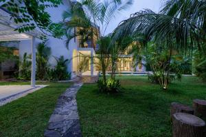 a house with a garden in front of it at Terrene Villa in Weligama