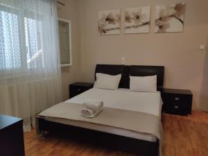 a bedroom with a bed with a towel on it at Matinas House in Neos Panteleimonas