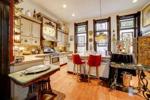 cocina grande con armarios blancos y sillas rojas en Vintage Studio in Historic Dtwn La Porte!, en LaPorte