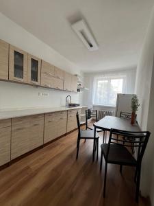 a kitchen and dining room with a table and chairs at Apartnám Sysel in Martin