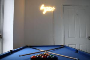 a room with a pool table with balls on it at Group Stay Sleeps 7 Manchester city contractors and family in Manchester