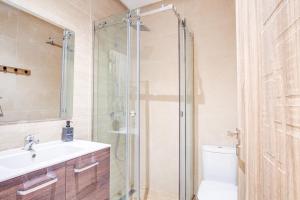 a bathroom with a shower and a sink and a toilet at Tanger Malabata - Chique & Stylish 2BR Apartment - Fast WiFi & Netflix in Tangier +15 photos