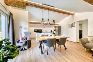 a kitchen and dining room with a wooden table and chairs at Haus Susanne in Bürserberg