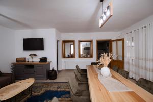 a living room with a couch and a table at Casuta de sub deal 