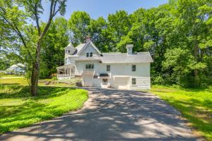 a large white house with a driveway at 2-Acre Property Victorian Home in Brownville! in Brownville