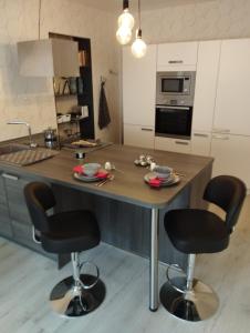 a kitchen with a large island with bar stools at Ferienwohnung Moselherz in Reil