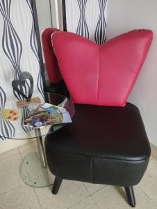 a red chair sitting next to a table at Ferienwohnung Moselherz in Reil