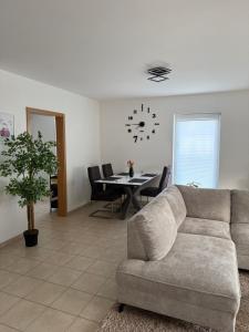a living room with a couch and a table at Modernes Apartment in Orscholz in Mettlach