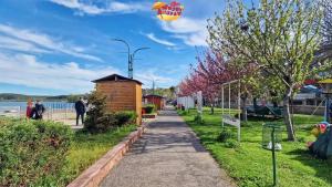 a kite flying in the sky over a sidewalk at Hris-An in Star Dojran