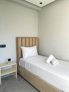 a bedroom with a bed and a night stand at Diplomatic Forest - CHU Family Apartment in Hajreien