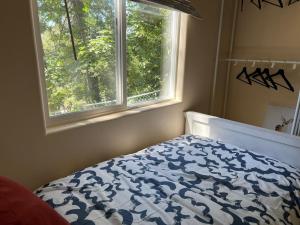 ein Schlafzimmer mit einem Bett und einem Fenster in der Unterkunft Cozy Cabin in Crestline