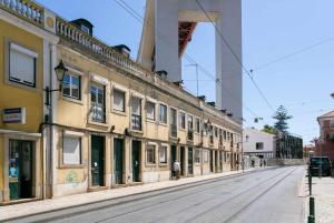 an empty street with an old building on the side at Studio Blue LX- 1 de Maio in Lisbon