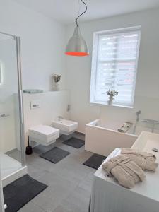 a bathroom with a shower and a tub and a sink at designAparts - II - by MorenoPisano in Bayreuth +12 photos
