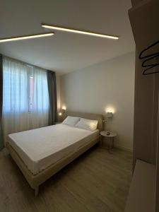a bedroom with a large bed and a window at Residence Corallina in Caorle
