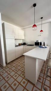 a kitchen with white cabinets and a white counter top at Casa Mare Costa Saracena - Castelluccio in Agnone Bagni
