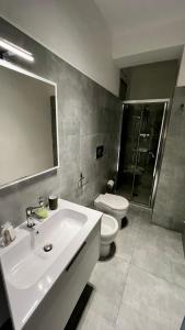 a bathroom with a sink and a toilet and a mirror at Casa Mare Costa Saracena - Castelluccio in Agnone Bagni