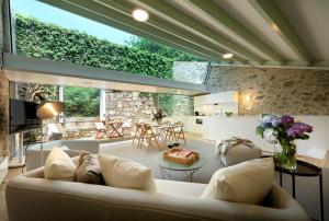 a living room with a couch and a table at Casas do Sarela by Upper Luxury Housing in Santiago de Compostela