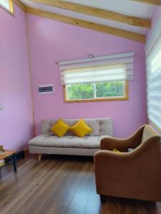 a living room with a couch and a window at Canto del Bosque in Castro