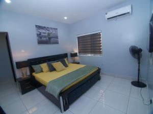 a bedroom with a bed and a window in it at Lekki holiday shortlet in Lekki +53 photos
