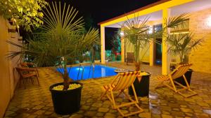 a patio with two chairs and a swimming pool at Green Land in Tbilisi City