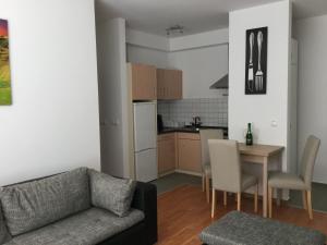 ブダペストにあるAdam's Apartment and Free Parkingのリビングルーム(ソファ、テーブル付)、キッチンが備わります。