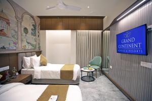 a hotel room with two beds and a sign at Grand Continent Dwarka in Dwarka