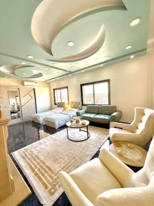 a living room with a couch and a table at Luxury 2 Bedroom Apartment in Amman