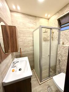a bathroom with a sink and a shower at Luxury 2 Bedroom Apartment in Amman +29 photos