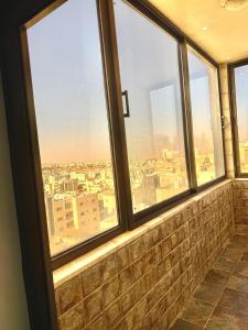 a view of a city from a room with windows at Luxury 2 Bedroom Apartment in Amman