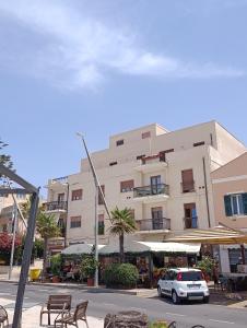 a white car parked in front of a building at L'Aragosta Guesthouse in Alghero