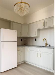 a kitchen with white cabinets and a white refrigerator at 2 Beds Free parking City Escape in Pittsburgh