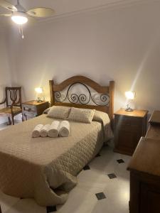 a bedroom with a bed with two towels on it at Vivienda Monterreal primera línea playa in Estepona
