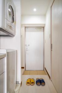 two pairs of shoes sitting on the floor in a kitchen at Yellow Submarine - Vacation STAY 67585v in Naha