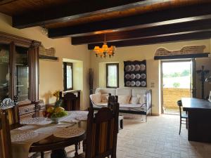 a living room with a table and a couch at Casale di Campagna in Monte San Giusto